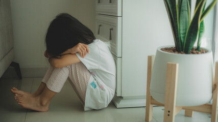 Lonely little sitting at home alone, upset unhappy child waiting for parents, thinking about...