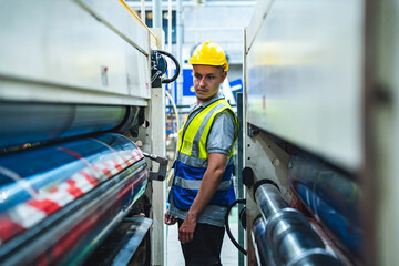 Expertise and technician engineer or worker is working, checking, determination and measuring a metal sheet, steel part or metallic quality of material before cutting by automatic machine in factory.