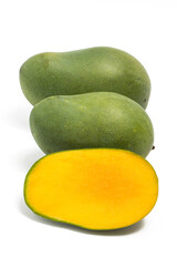 Half cut and two whole fresh organic green mango delicious fruit side view isolated on white background clipping path