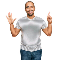 Hispanic adult man wearing casual clothes showing and pointing up with fingers number six while smiling confident and happy.