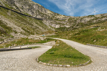 Hairpin bend on the historic Tremola road, a winding mountain road with cobblestones leading from...