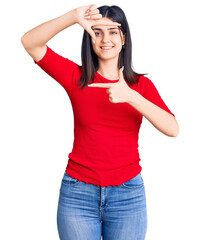 Young beautiful girl wearing casual t shirt smiling making frame with hands and fingers with happy face. creativity and photography concept.