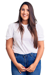 Young beautiful brunette woman wearing casual t-shirt looking positive and happy standing and smiling with a confident smile showing teeth