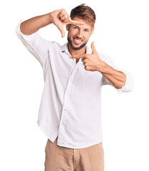 Fototapeta premium Young caucasian man wearing casual clothes smiling making frame with hands and fingers with happy face. creativity and photography concept.