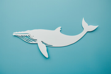 Decorative whale cut out of paper on a blue background. Marine Life Protection Day
