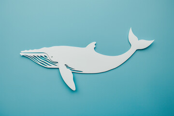 Fototapeta premium Decorative whale cut out of paper on a blue background. Marine Life Protection Day