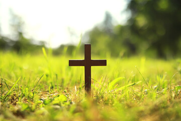 Concept conceptual black cross religion symbol silhouette in grass