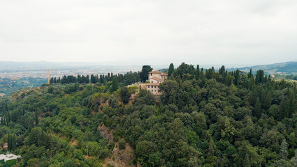Fototapeta na wymiar Florence, Italy. Villa on a mountain covered with forest. Suburb. Summer, Aerial View