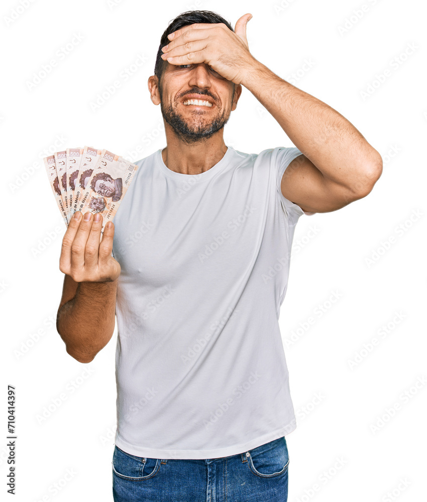 Canvas Prints handsome man with beard holding 50 mexican pesos banknotes stressed and frustrated with hand on head