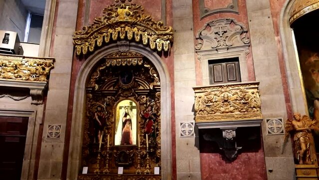 Ornate church altar with religious icons, sculptures and paintings in a baroque style architecture. Igreja dos Clerigos, Porto