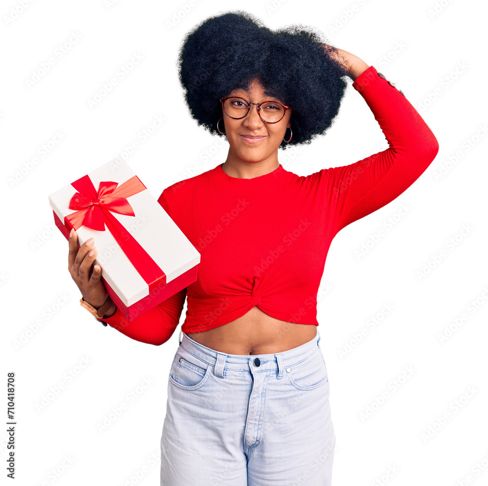 Canvas Prints Young african american girl holding gift confuse and wondering about question. uncertain with doubt, thinking with hand on head. pensive concept.