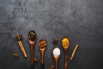 Wooden spoons with spices. A mixture of peppers and spices. Fragrant herbs for food.