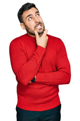 Young hispanic man wearing casual clothes thinking worried about a question, concerned and nervous with hand on chin