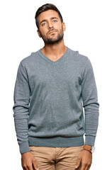 Fototapeta premium Handsome hispanic man wearing casual clothes relaxed with serious expression on face. simple and natural looking at the camera.