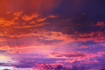 Beautiful sunset sky above clouds with dramatic light. Cabin view from airplane