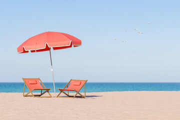 two red deck chairs under a large red umbrella on a beach, with a clear blue sky and seagulls in the distance, summer vacation concept.