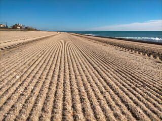 Vilassar de Mar-Barcelona beach, first thing in the morning in summer, freshly brushed with the...