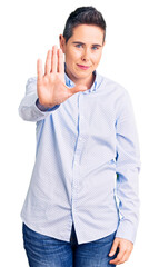 Naklejka premium Young woman with short hair wearing business clothes doing stop sing with palm of the hand. warning expression with negative and serious gesture on the face.