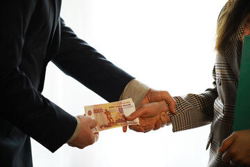 Businessmen secretly passing money - bribery and corruption concepts