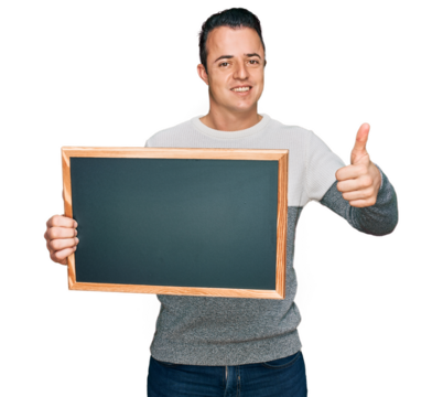 Handsome young man holding blackboard smiling happy and positive, thumb up doing excellent and approval sign - Powered by Adobe