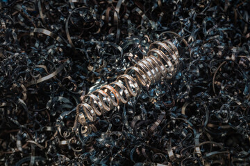 Metal spiral shavings after working on a lathe. Angled view. Background for design.