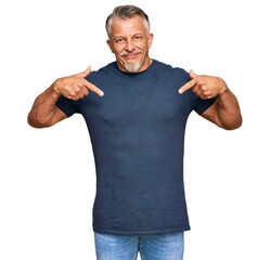 Middle age grey-haired man wearing casual clothes looking confident with smile on face, pointing oneself with fingers proud and happy.