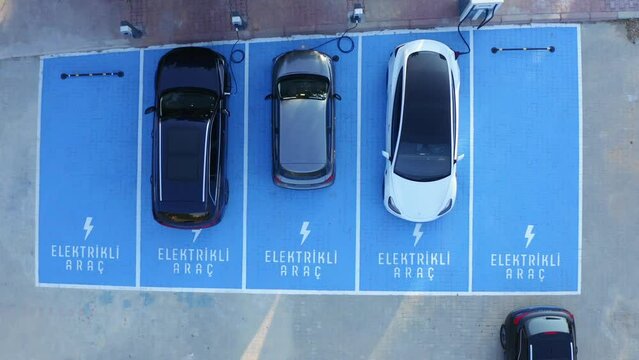 Electric vehicles charging at car supercharger station. clean energy.  Aerial view.