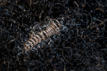 Metal spiral shavings after working on a lathe. Angled view. Background for design.