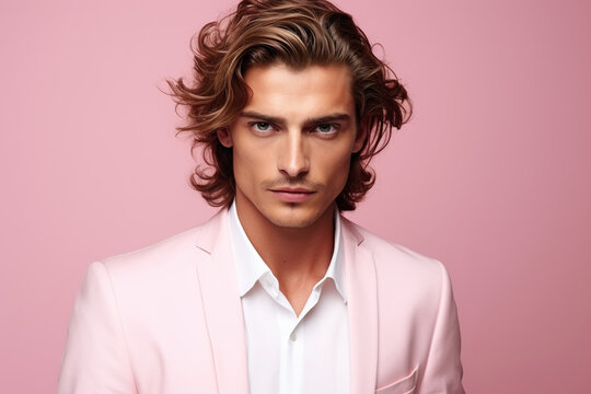 Portrait of fashion caucasian male model on pink background.