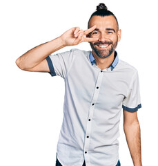 Fototapeta premium Hispanic man with ponytail wearing casual white shirt doing peace symbol with fingers over face, smiling cheerful showing victory