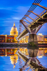 Fototapeta premium London, England - UK. St Paul's Anglican cathedral dome and Millennium Bridge, early in the evening twilight Thames River water reflection, United Kingdom.
