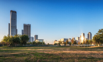 Lush Urban Park Against Modern City Skyline