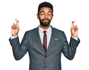 Young african american man wearing business clothes gesturing finger crossed smiling with hope and eyes closed. luck and superstitious concept.