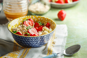 Healthy breakfast oatmeal porridge bowl with nuts and strawberries
