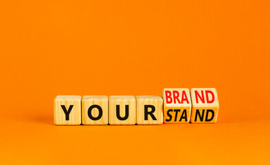 Branding your brand or stand symbol. Concept words Your stand Your brand on beautiful blocks. Beautiful orange table orange background. Business branding your brand or stand concept. Copy space.