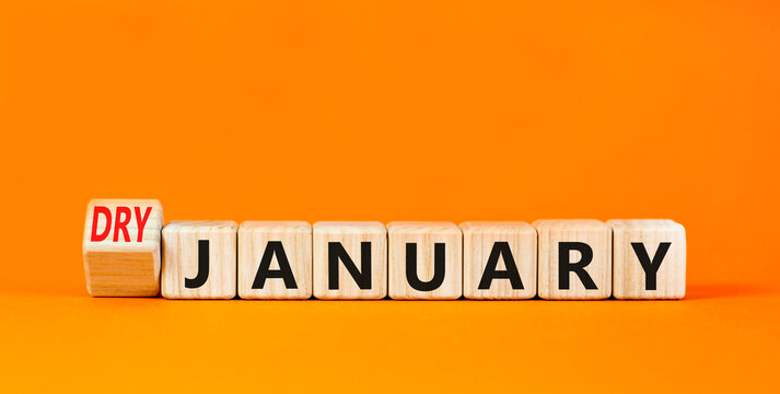 Dry January challenge symbol. Concept words Dry January on beautiful wooden cubes. Beautiful orange table orange background. Dry January healthy lifestyle concept. Copy space.