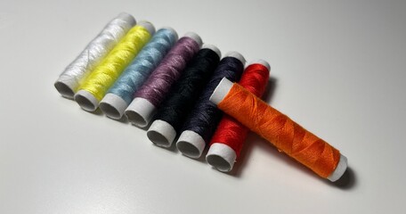 spools of thread on a white background. multi-colored threads.