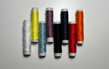 spools of thread on a white background. multi-colored threads.