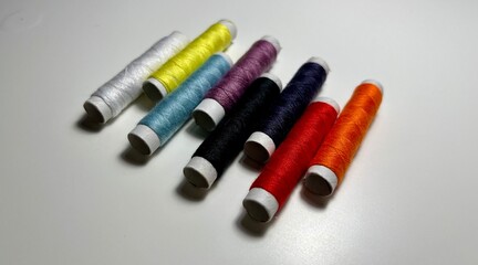 spools of thread on a white background. multi-colored threads.