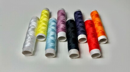 spools of thread on a white background. multi-colored threads.