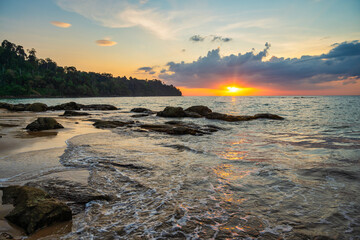 Tropical sea beach sunset with rock coast and ocean wave at Khao Lak, Phang Nga Thailand nature landscape