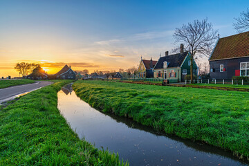 Obraz premium Sunrise at Zaanse Schans village with Dutch traditional house near Amsterdam Netherlands