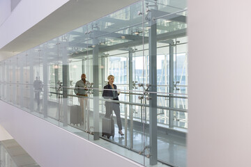 Business executives walking through airport terminal