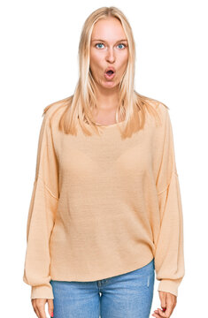 Young blonde girl wearing casual clothes afraid and shocked with surprise expression, fear and excited face.