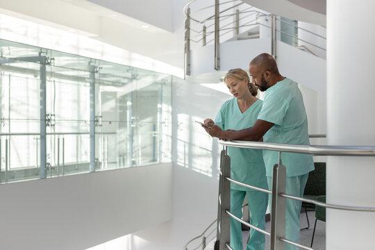 Doctors in a modern hospital looking at results on a digital tablet - Powered by Adobe