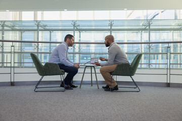 Businessmen meeting in an office using a digital tablet