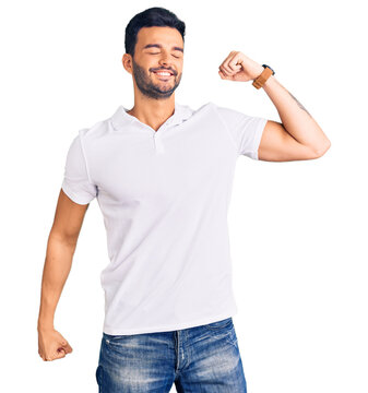 Young handsome hispanic man wearing casual clothes stretching back, tired and relaxed, sleepy and yawning for early morning