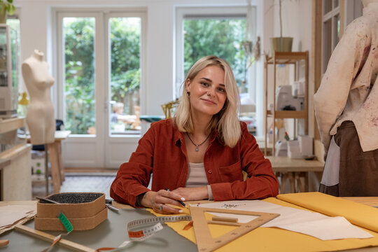 Portrait of fashion student in college working on a pattern