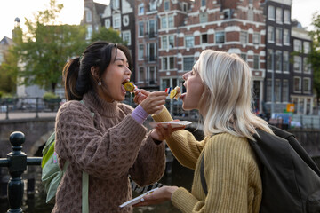 Female tourists eating local food in Amsterdam