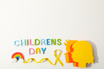 Fototapeta premium Children's heads made of paper with a yellow ribbon
